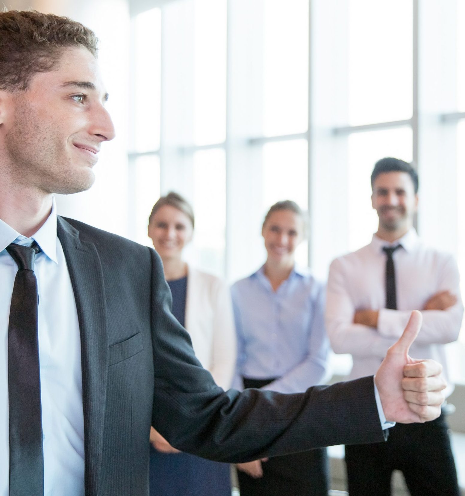 Confident handsome employer showing thumb-up