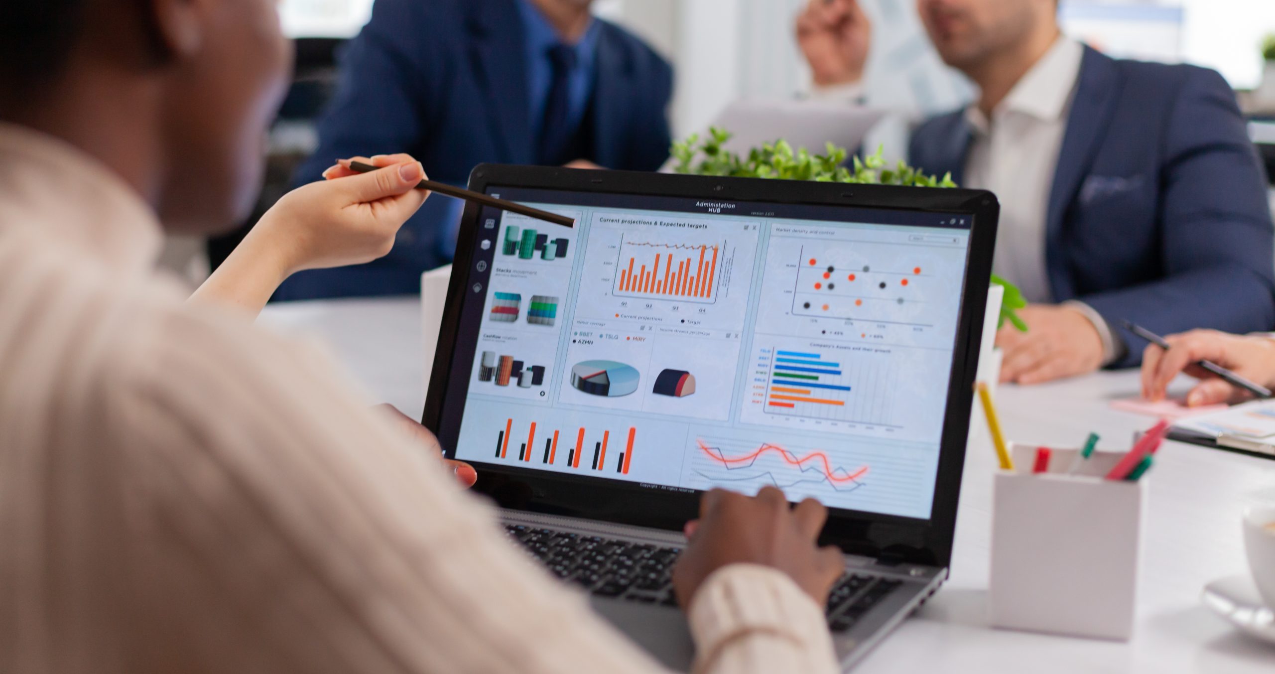 Multi-ethnic business team sitting at table in office center speaking
